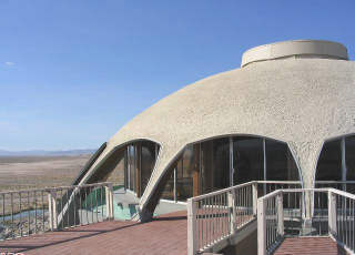 Illustration for article titled A House Shaped Like a Flying Saucer, Perched Atop a Volcano